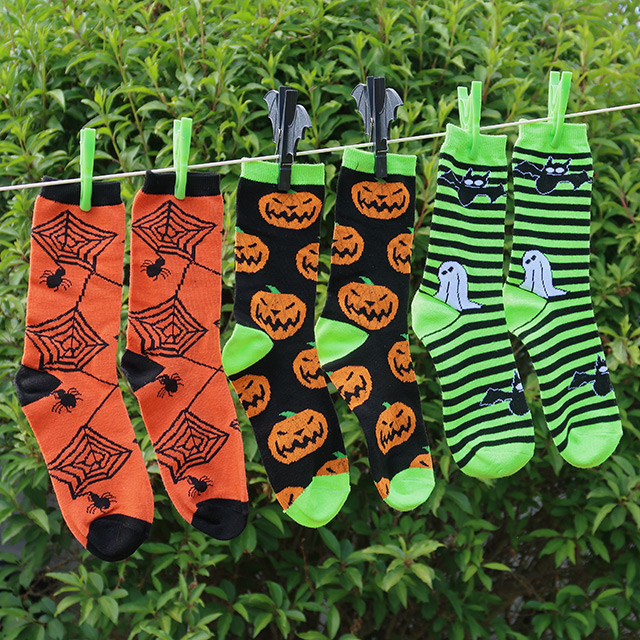 Spooky socks in three designs on a washing line