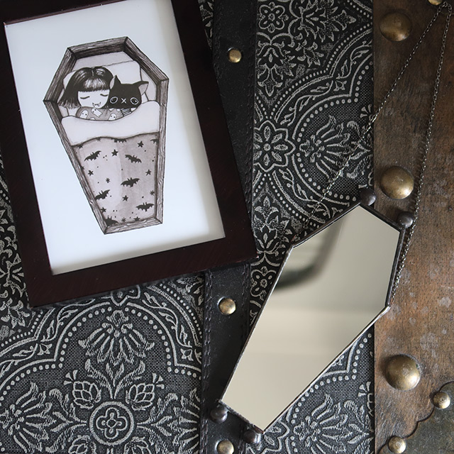 A Print by Marcies Art and a coffin-shaped mirror by August Glass Designs
