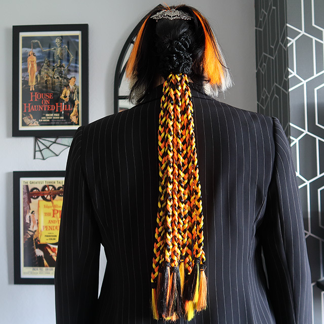 Long black, orange and yellow plaits, with orange and white weft clip-in hair