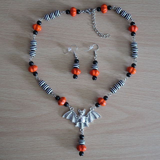 Striped bat necklace and earrings (overhead view)