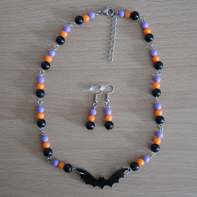Bat necklace and earrings (overhead view, variation 1)
