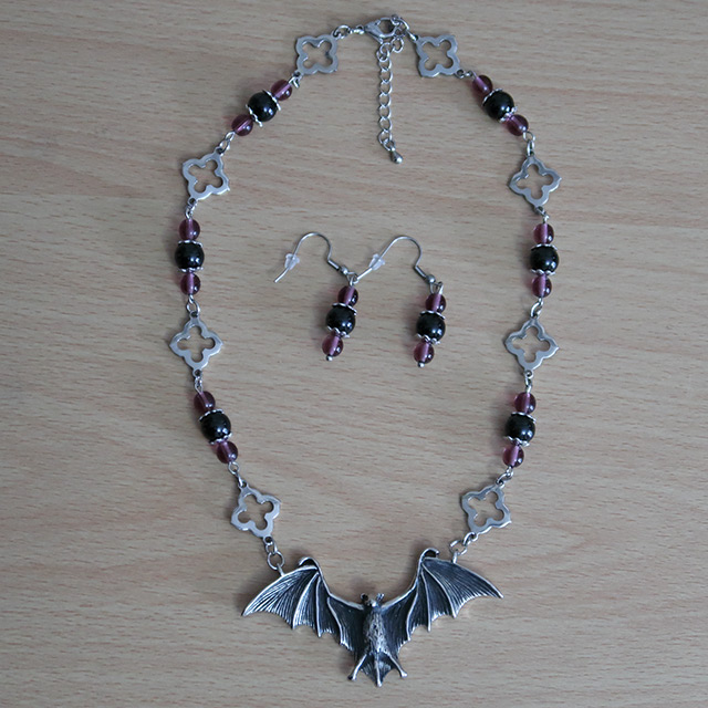 Bat necklace and earrings (overhead view)