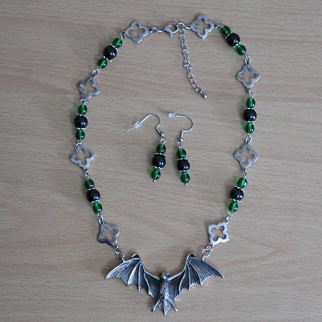 Bat necklace and earrings (overhead view)