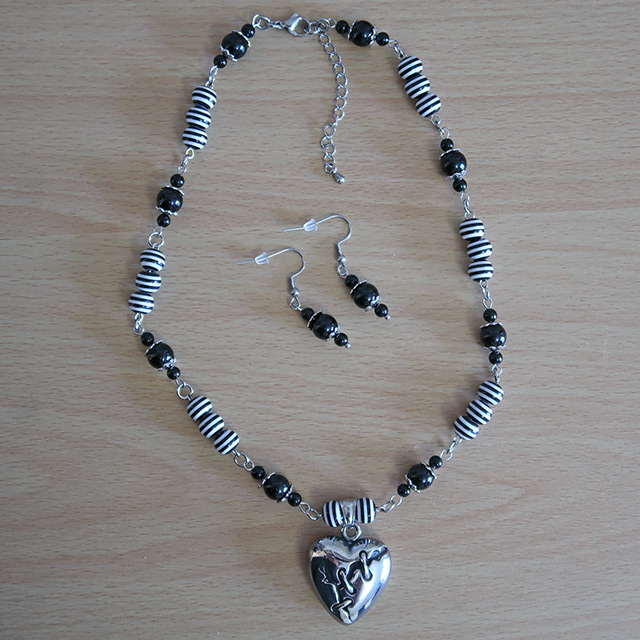 Broken Heart necklace and earrings (overhead view)