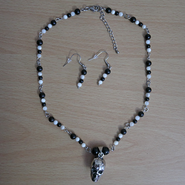 Skull necklace and earrings (overhead view)